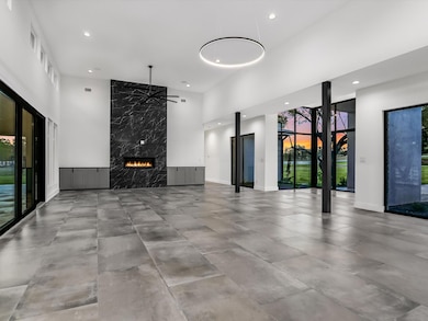 Unfurnished living room with a high ceiling, reces