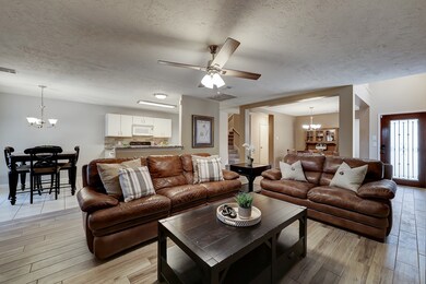 Step into the heart of the home.  The living area is open to the kitchen and formal dining.  The uninterrupted flow of the living area, kitchen and dining allow for many options in arranging your space.