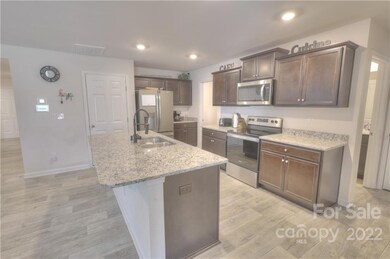 Almost new kitchen with large island, granite countertops and stainless appliances