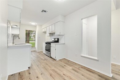 Kitchen with stainless steel range with gas cookt