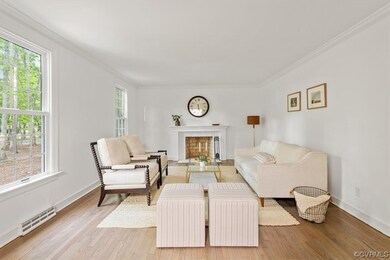 Living room with crown molding, a baseboard radiat