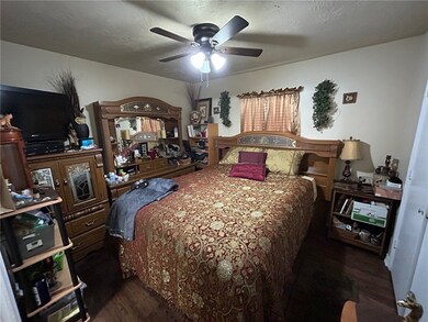 Bedroom featuring dark wood-style flooring and a c