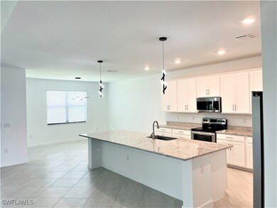 Kitchen featuring stainless steel appliances, a si