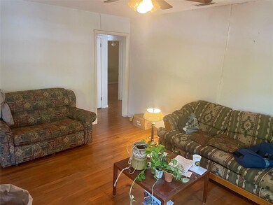Living room with hardwood / wood-style flooring an