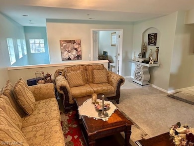Living area with carpet flooring and baseboards