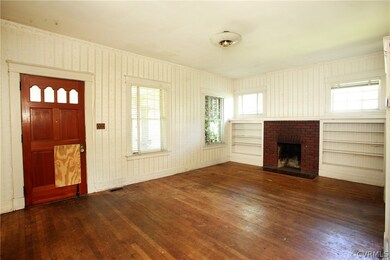 Living room with hardwoods, fireplace, and built'ins