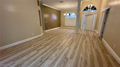 Entryway featuring a chandelier, ornamental moldin
