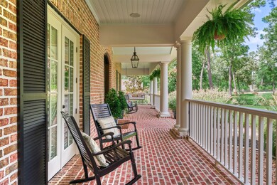 There is an expansive porch that wraps around the front exterior. Relax on the front porch swings while watching the world go by. There is access from multiple entry points to the home and an outdoor dining area directly accessed from the downstairs gameroom.