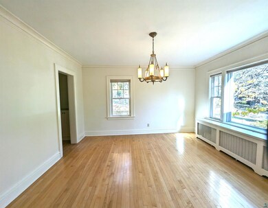 Spare room with crown molding, a chandelier, radia