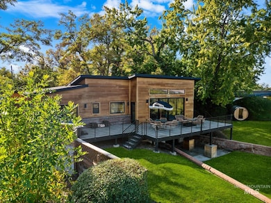 Back of house featuring a wooden deck and a yard