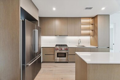 Kitchen featuring open shelves, premium appliance