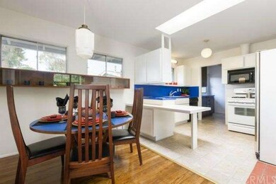 Dining room with the kitchen beyond.