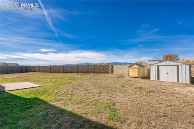 Fenced backyard with a storage shed
