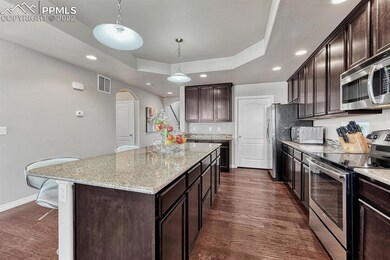 The Kitchen has beautiful espresso cabinets with g