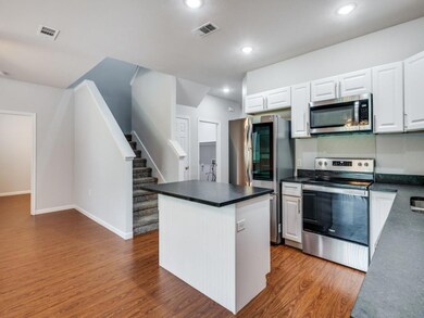 Kitchen featuring a kitchen island, appliances wit