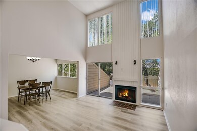 Living room featuring a high ceiling, wood finish