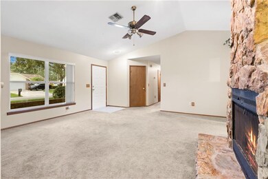 Living room with view of entry and hallway to bedr