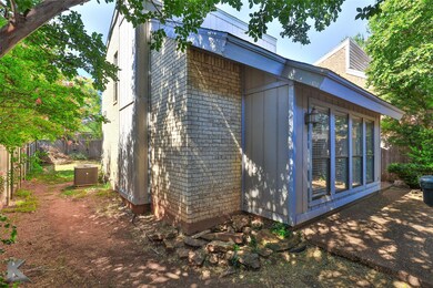 View of side of home with cooling unit