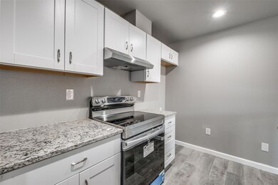 Kitchen with stainless steel electric stove, white