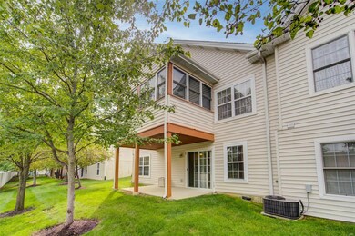 Rear view....three season room and covered lower level patio