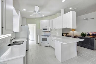 Kitchen featuring decorative backsplash, white cab