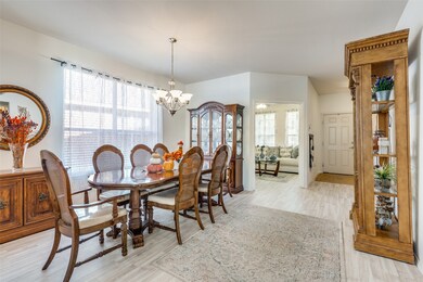 Dining area featuring light wood finished floors and a chandelier