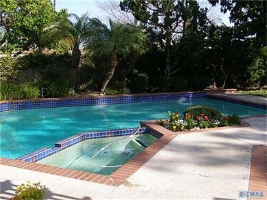 Trees and flowers surround the pool and spa. Very private!