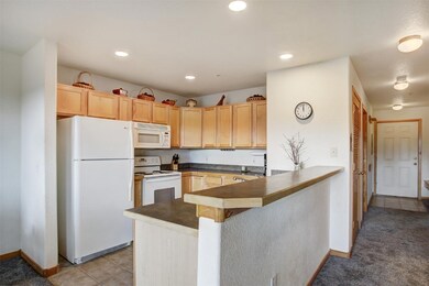 Spacious kitchen area with tile flooring and beakf