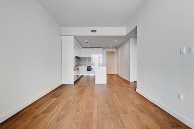 Unfurnished living room featuring light wood fini