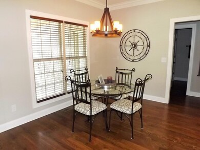 Breakfast room with hardwood floor and unique light fixture!