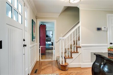 The foyer is welcoming with hardwood floors, shado