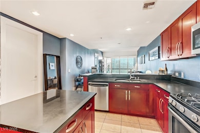 Kitchen featuring dark countertops, visible vents,