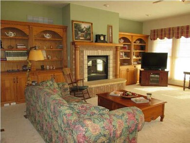 Living room has beautiful gas fireplace with built