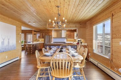 Dining space with wood walls, dark hardwood / wood