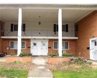 View of exterior entry featuring brick siding