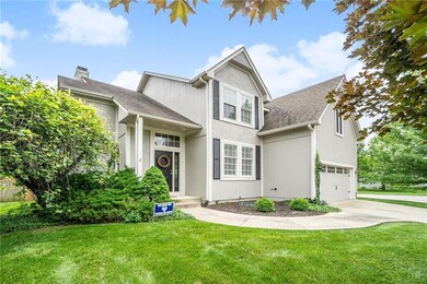 Stucco front, accent shutters and a carriage garag