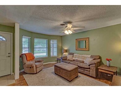 Living Room. laminate wood floors, bay windows, an