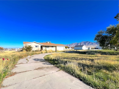 Single story home with a mountain view and driveway