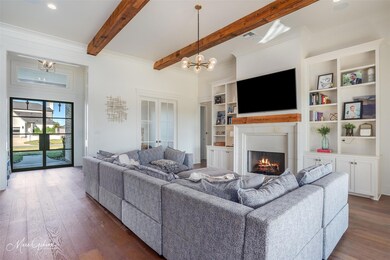 Living room with beam ceiling, crown molding, dark