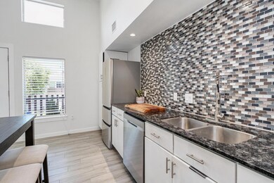 Kitchen featuring stainless steel dishwasher, dec