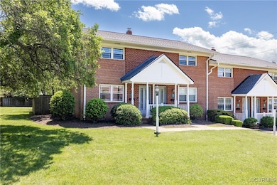 View of front of home featuring brick siding, a po