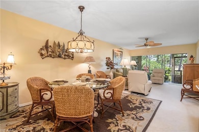 Carpeted dining area featuring ceiling fan