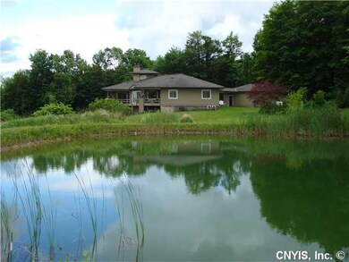 Exterior Back. A private pond is featured in the l