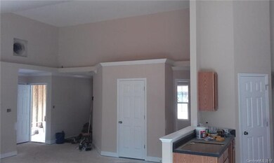 Living Room with Vaulted Clg, Plant Shelf Above an