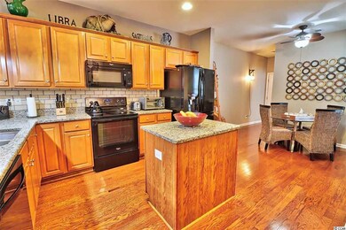 Gleaming wood floors, a breakfast bar with pendant