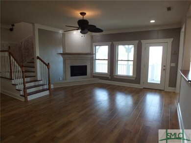 Living room with tabby fireplace, marsh views and