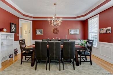 Formal dining with hardwood floors, tray ceiling,