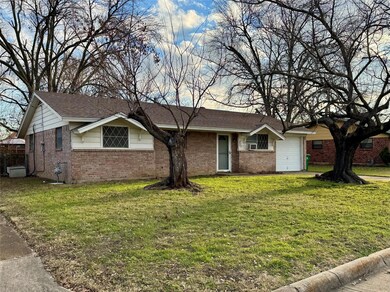 Single story home featuring a front yard and a gar