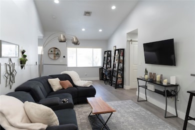Large bright living room with vaulted ceilings and recessed lighting