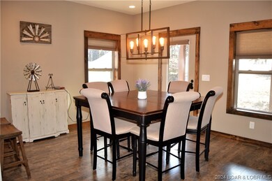 Dining room is surrounded by windows and access to